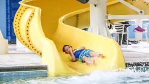 boy-going-down-slide-splash-buffaloe-road-aquatics-parks