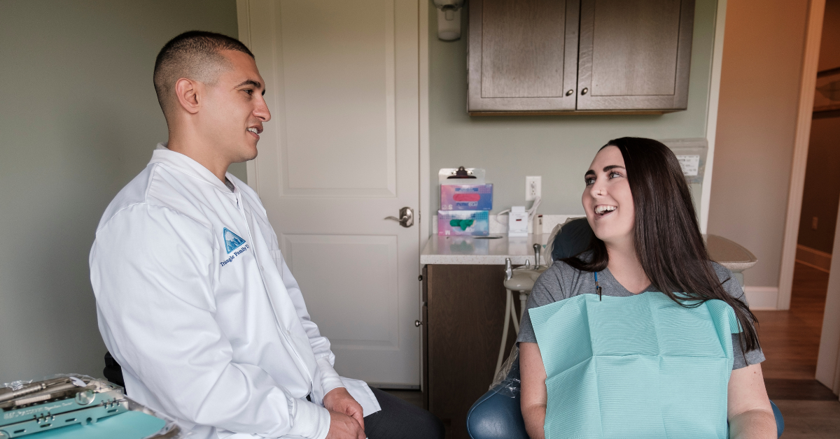 Dental patient consulting with a dentist at Triangle Family Dentistry
