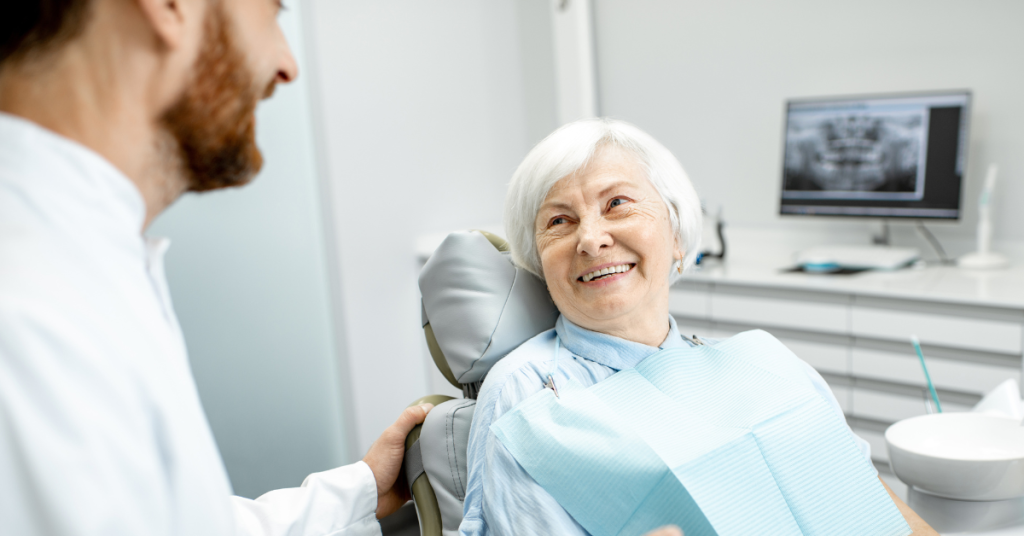 An older dental patient providing feedback to their dentist (testimonial)