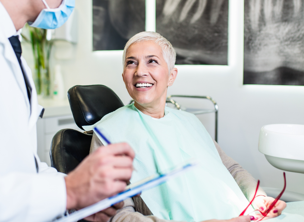 Older woman smiling and discussing multi dental implants with their dentist
