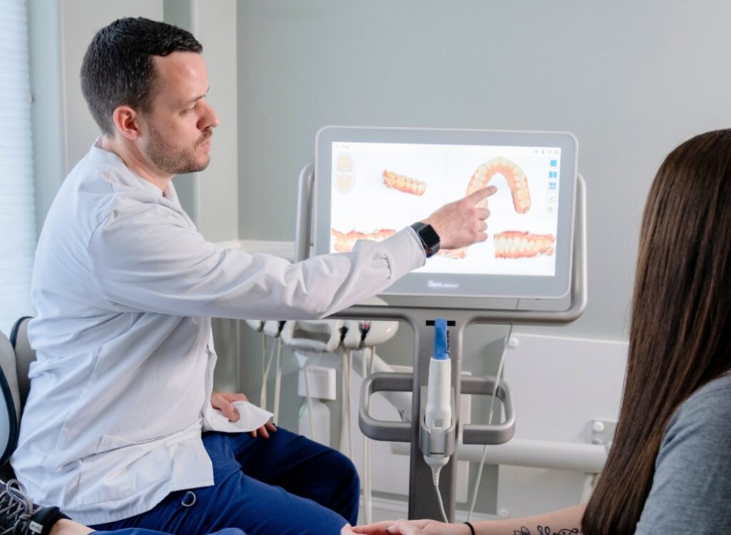 doctor showing patient pictures of their teeth